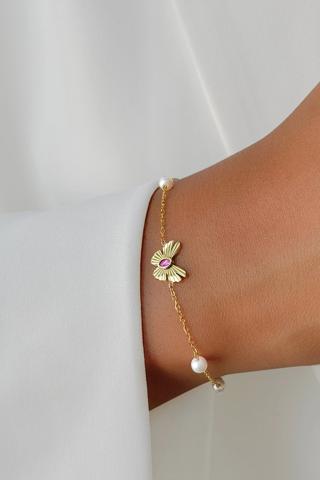 Fly Pearl Bracelet styled on wrist – modern fine jewelry piece with timeless pearl elegance