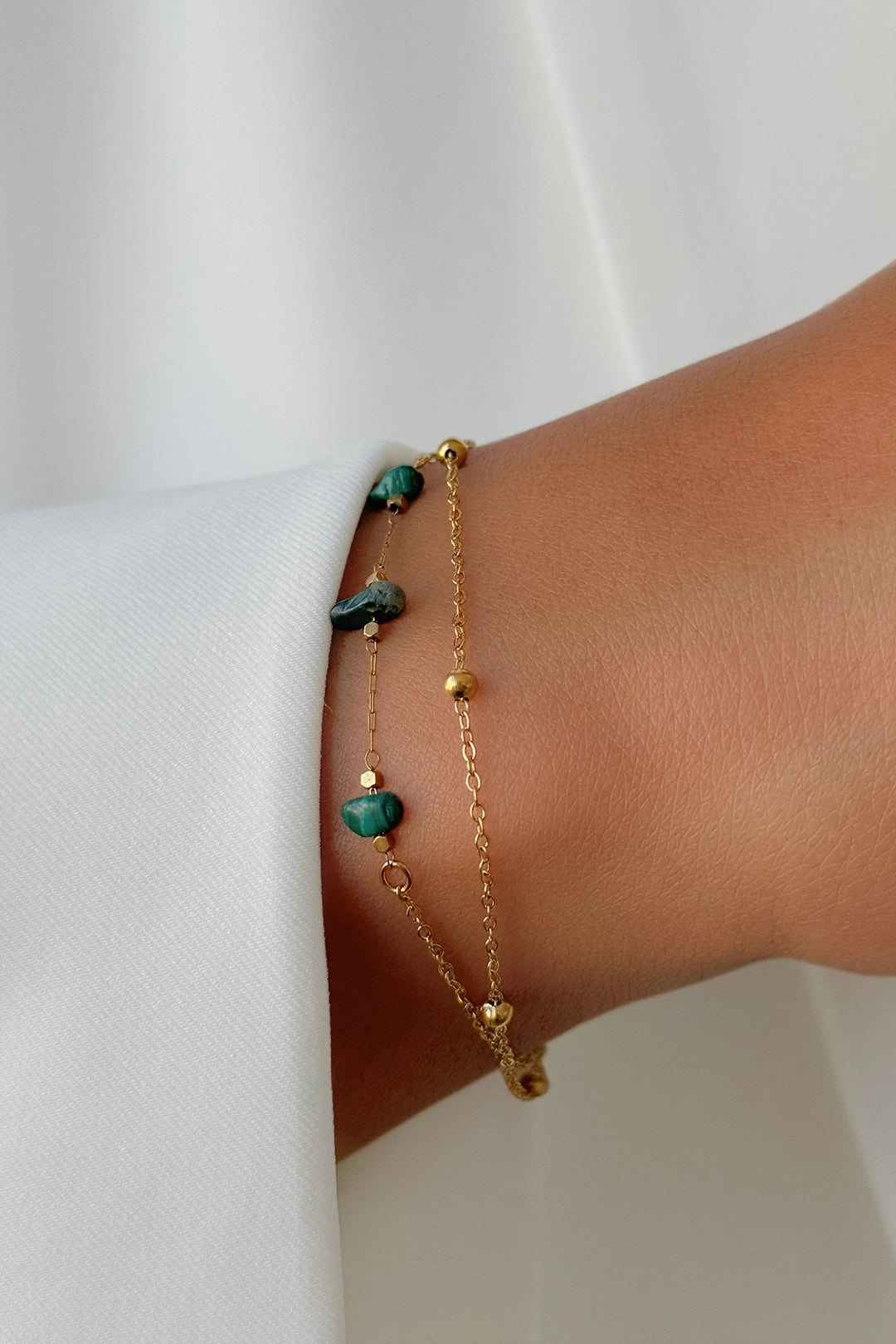 Elegant green and gold bracelet styled on wrist – fine jewelry piece for everyday or gifting